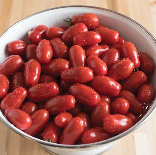 Photo of a bowl of red pear-grape tomatoes. This is a link to the Tomato section of Wilson Home Farm's Digital Seed Catalog